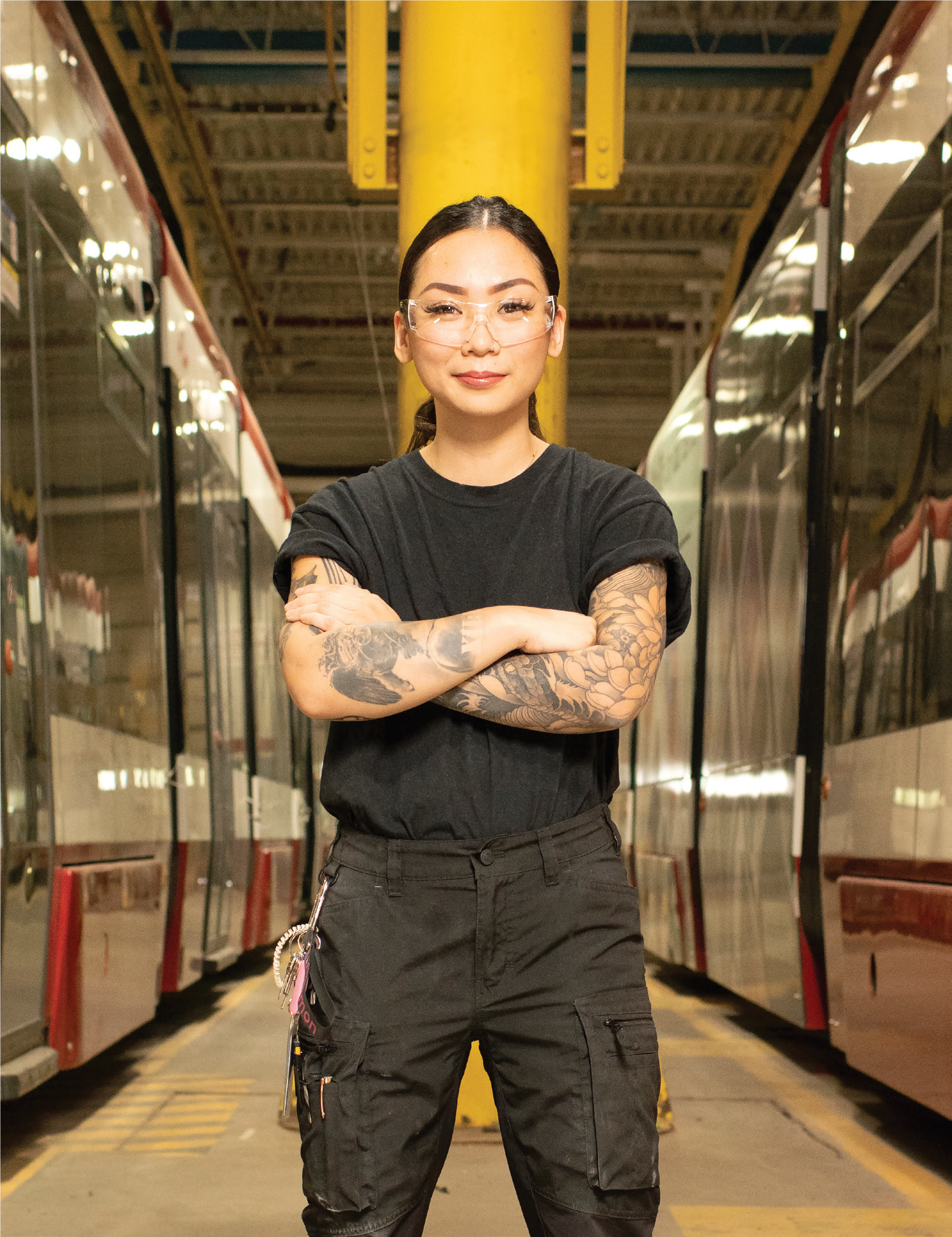 TTC worker standing on a platform between two trains