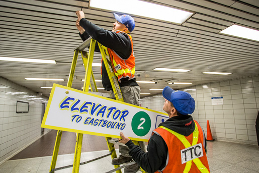 Workers put the finishing touches on signage at Bathurst Station.