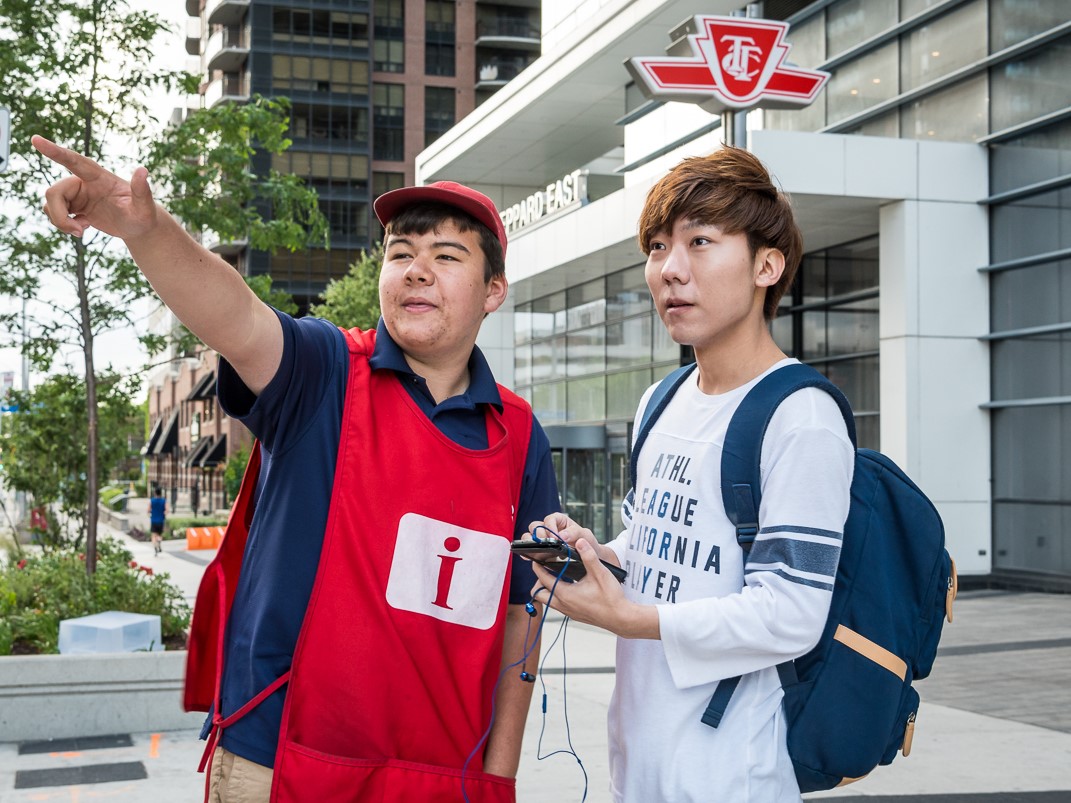 Red smock customer service employee assisting a customer