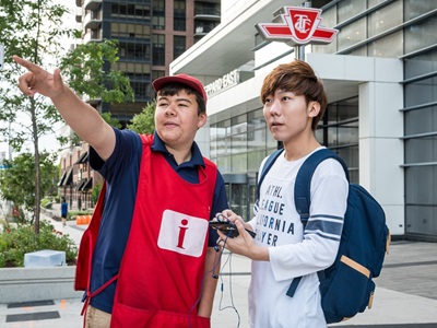 Red smock customer service employee assisting a customer