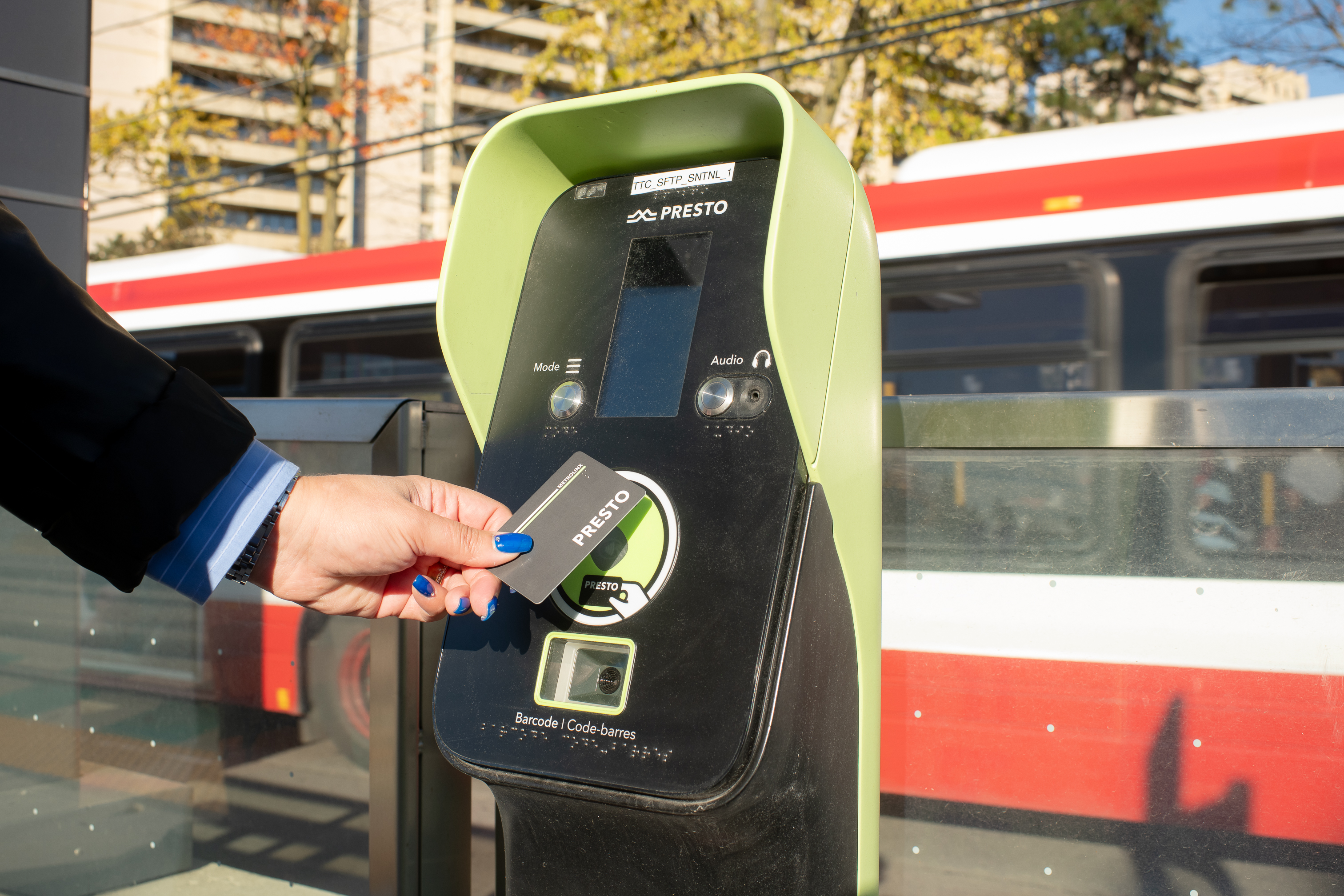 TTC rider tapping a PRESTO card on the fare payment machine