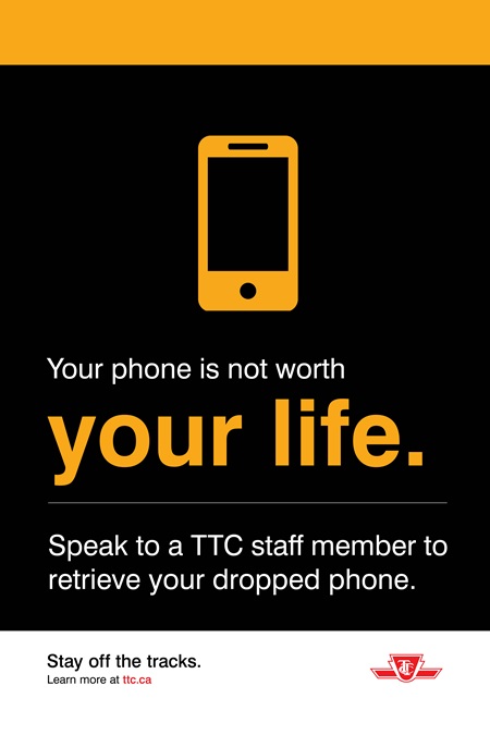 Poster having black back ground and yellow text with message Your phone is not worth your life. Speak to a TTC staff member to retrieve your dropped phone