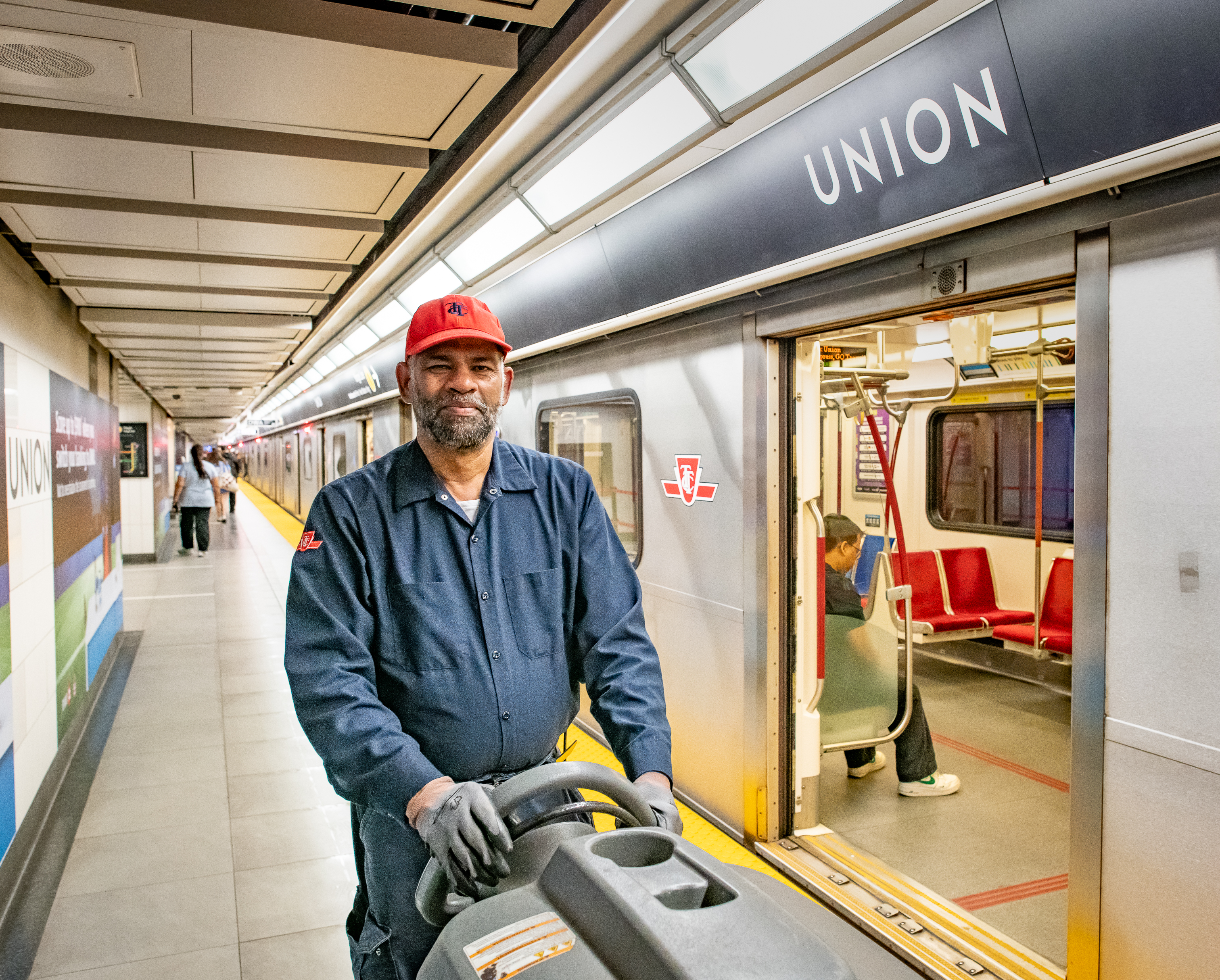 A TTC employee cleaning a subway platform at Union Station.