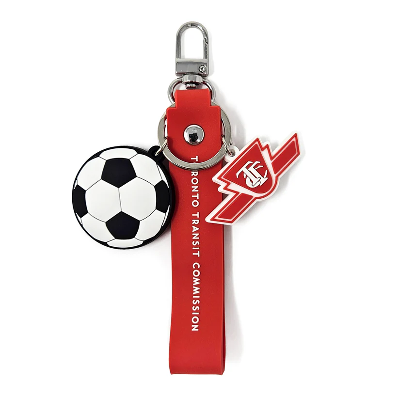 A TTC soccer key chain with a red band, soccer ball charm and a red and white TTC logo charm