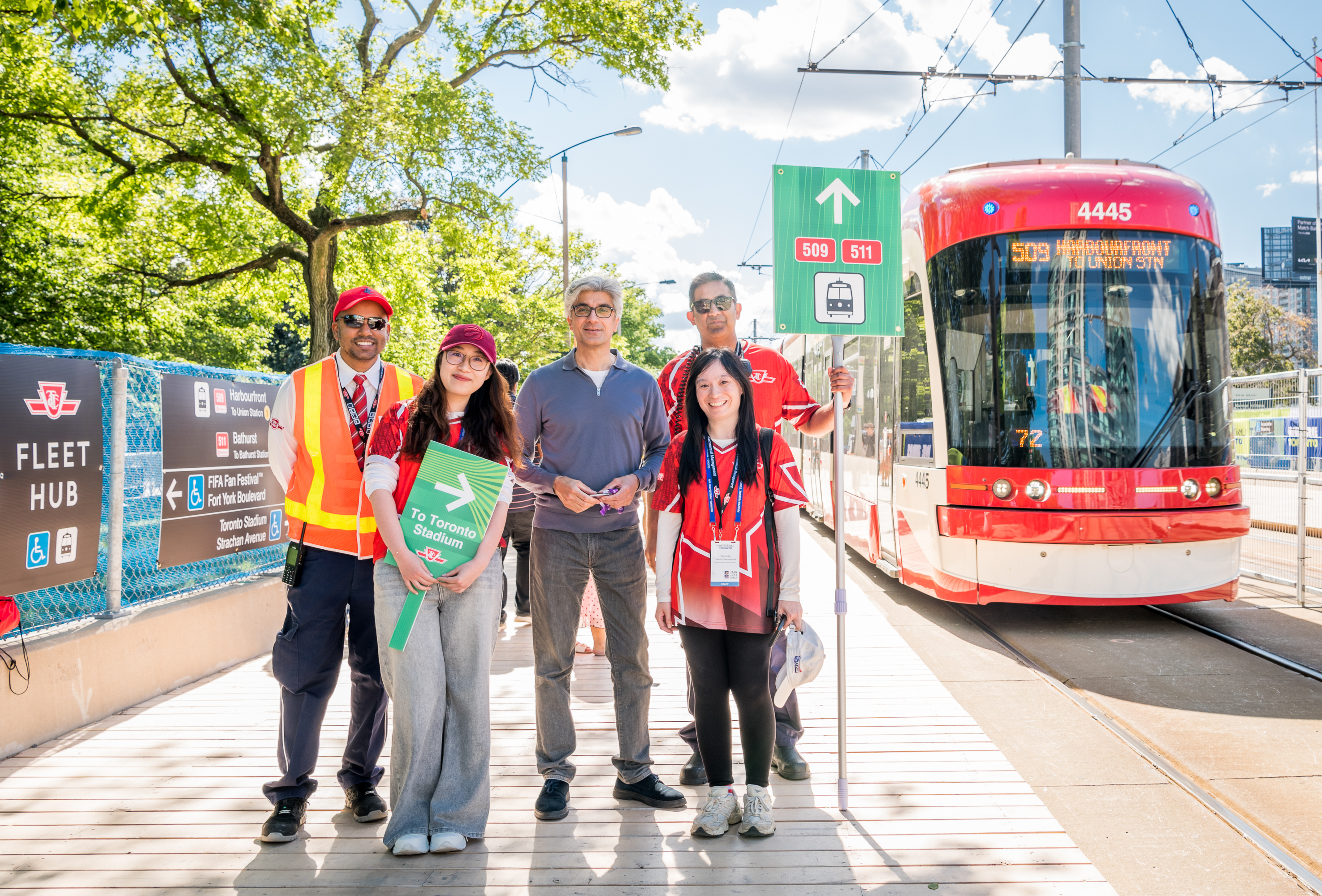 TTC employees and TTC CEO Mandeep S. Lali beside a 509 Harbourfront Streetcar.