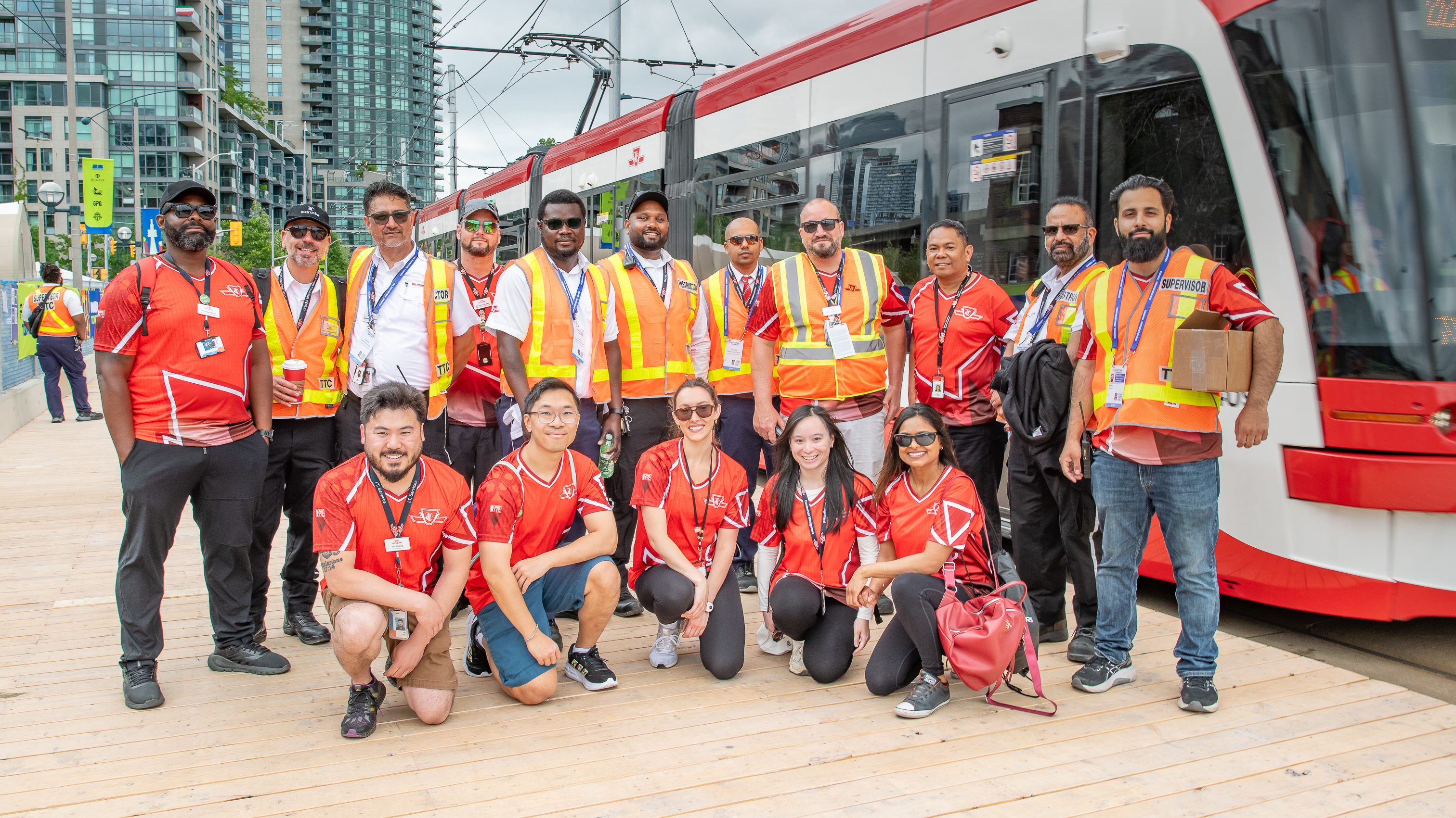 TTC employees and ambassadors standing beside a streetcar.