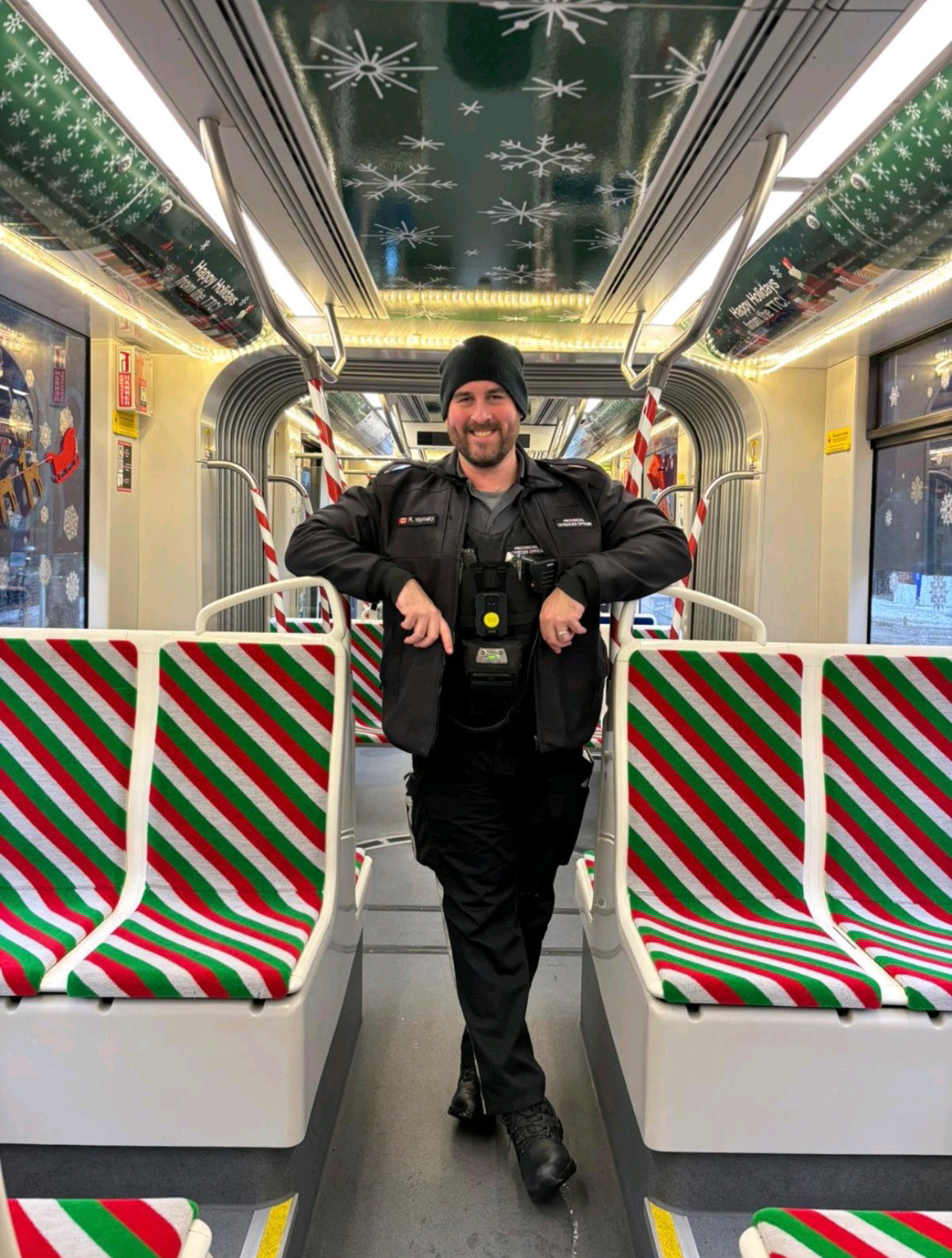 TTC Provincial Offences Officer Ryan on a decorated holiday subway train.
