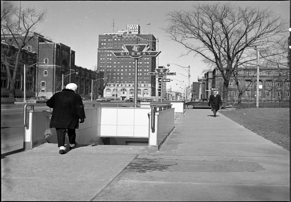 Photo of a pedestrian descending into the Museum Station subway entrance/exit in 1963.