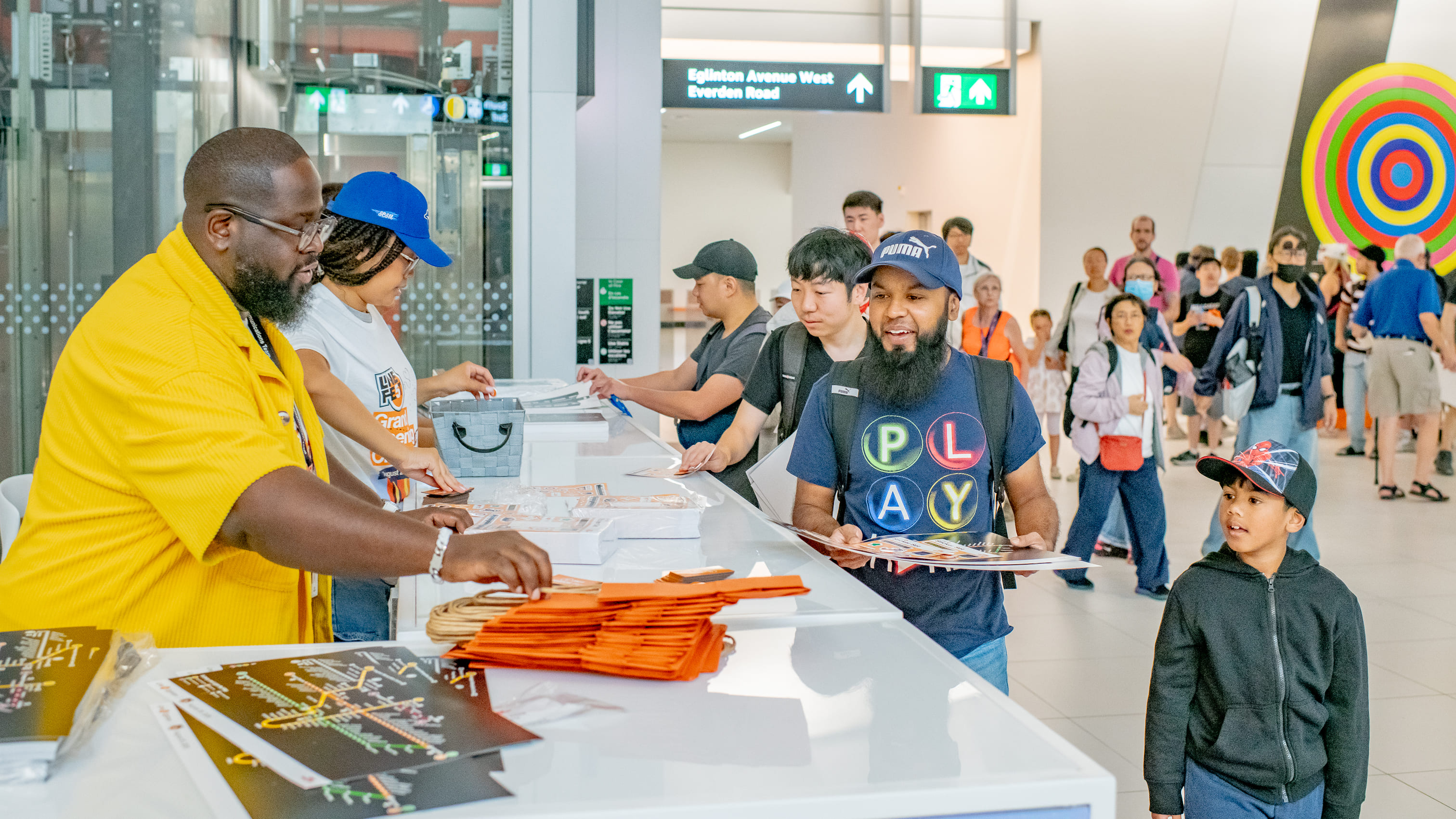 TTC staff at an info booth handing out materials and giveaways to the arriving attendees of the celebration