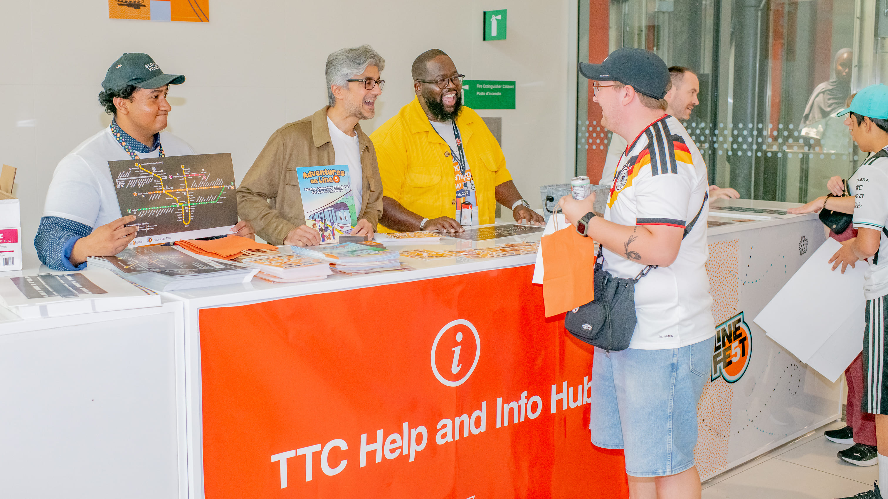 TTC CEO Mandeep S. Lali and TTC Staff share a laugh with a visitor at the TTC Help and Info Hub at the event