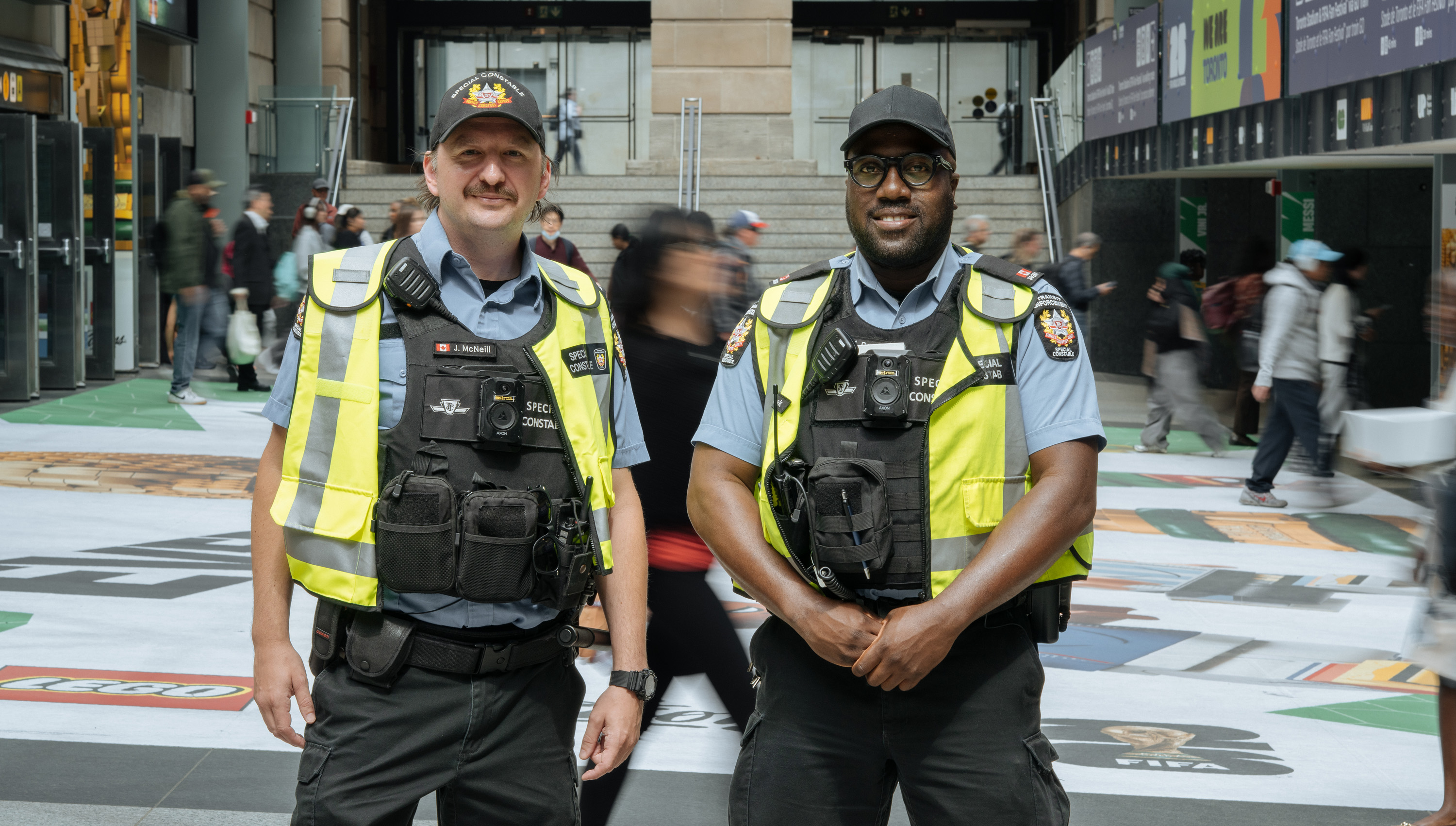 TTC Special Constables standing in a busy subway station.