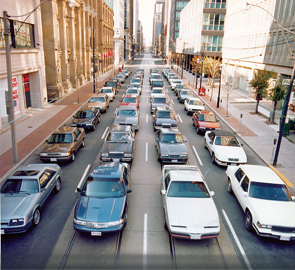 First image in a sequence of four, a downtown Toronto street congested with traffic.