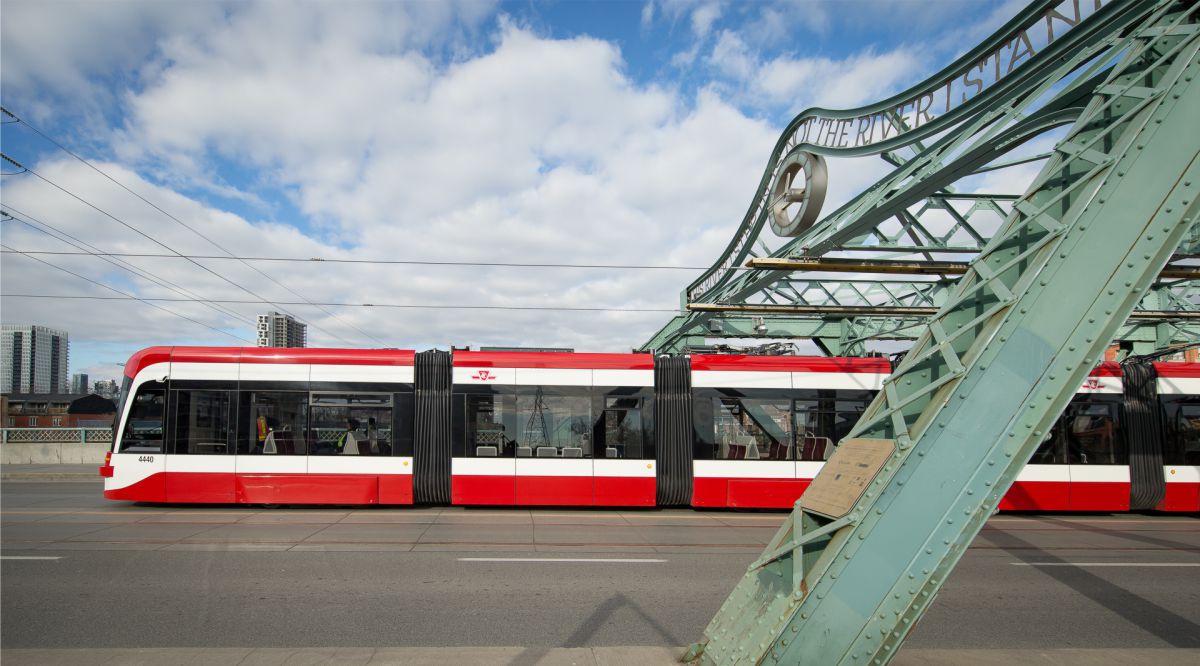 New Streetcar passing next to iron structure
