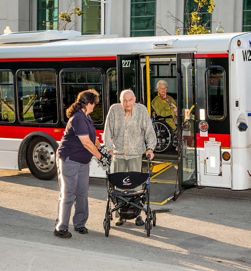 A Wheel-Trans operator assisting a Wheel-Trans passenger
