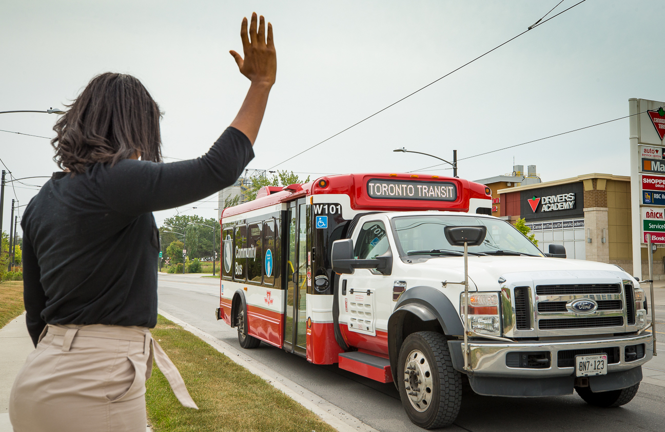 A customer flagging a Wheel-Trans bus