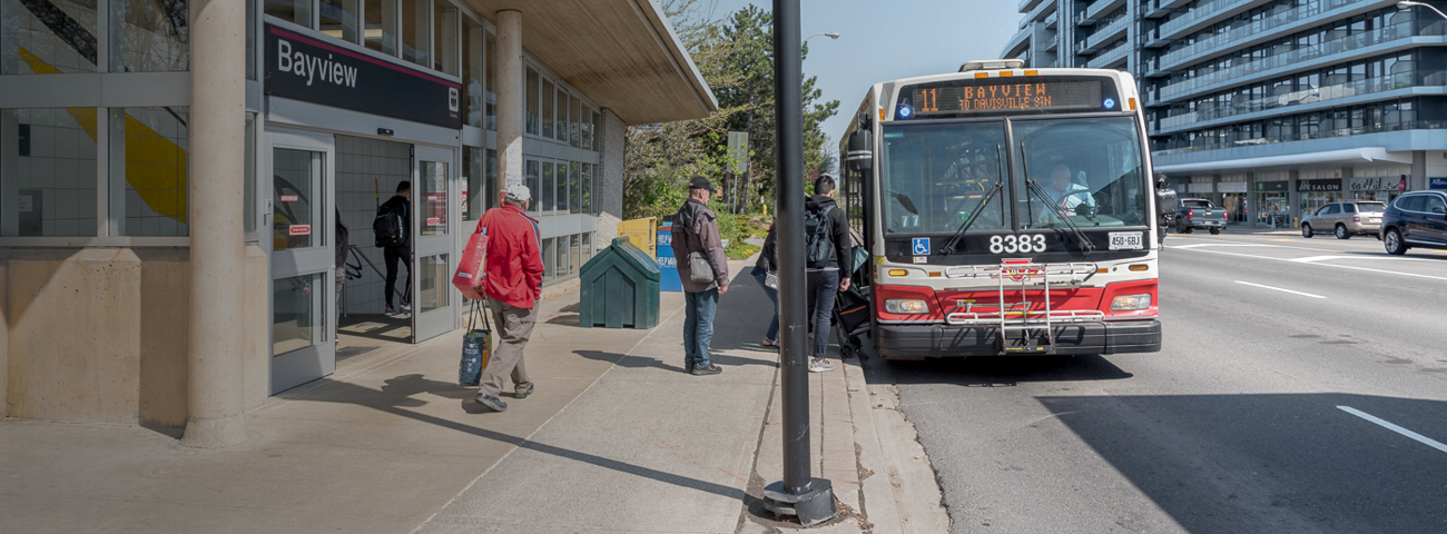 Passengers boarding TTC bus in front of  Bayview Station