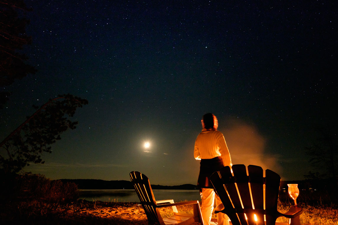 A beautiful clear night on Three Mile Lake. Campfire, glass of wine, lake, moon and the stars. Photo courtesy Brian Li.
