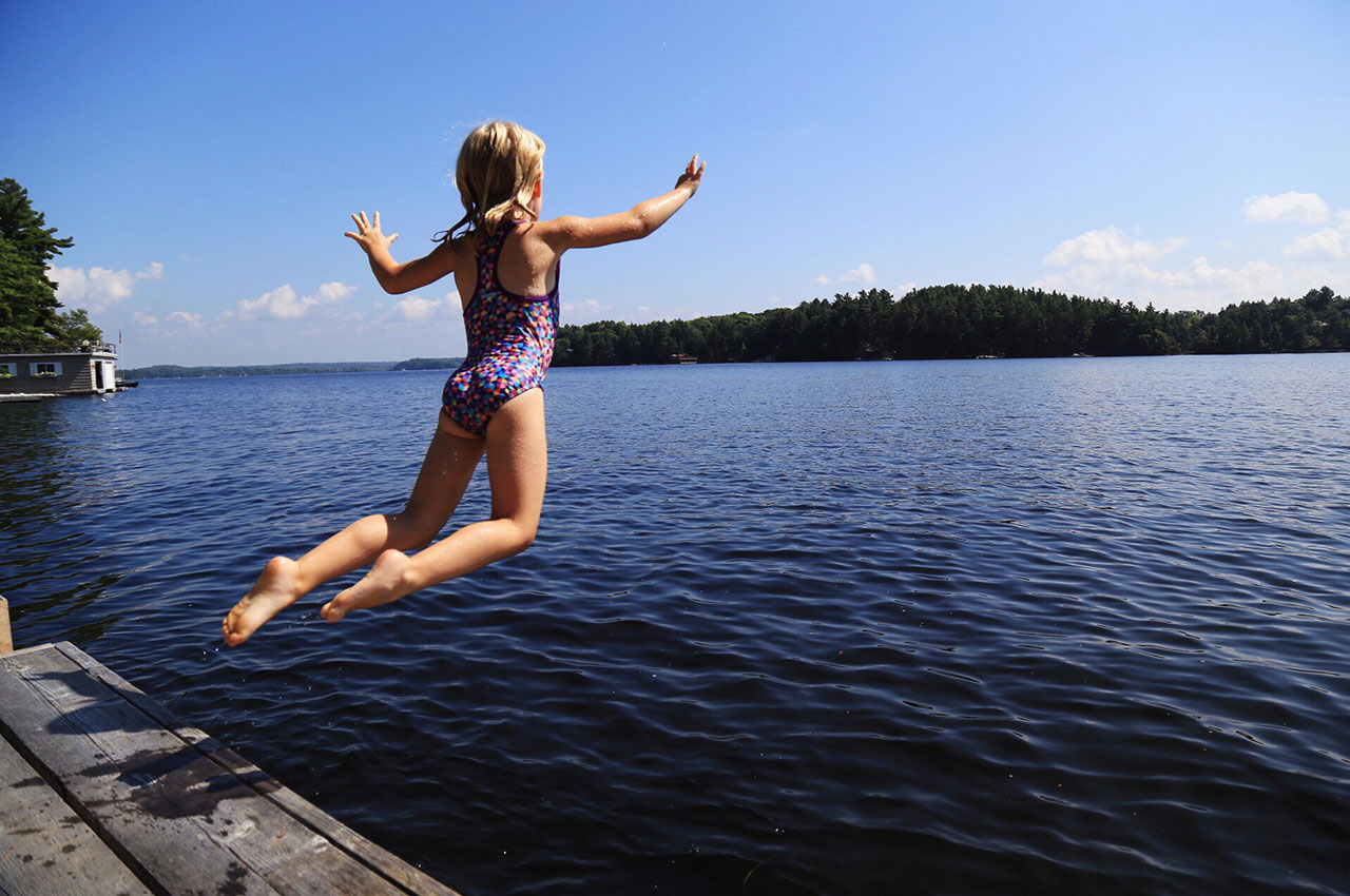 Norah jumping off the dock into Lake Muskoka. Photo courtesy Jessica Kosmack