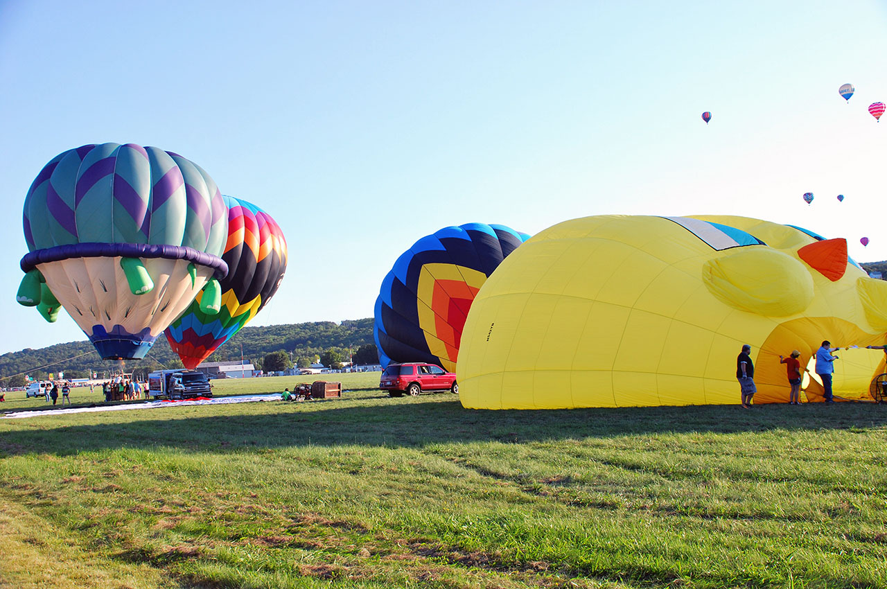 Hot air balloon festival at Dansville, N.Y. Labour Day weekend. My daughter in red shirt at the right, volunteered to help inflate the balloon. Photo courtesy Roy Tejares