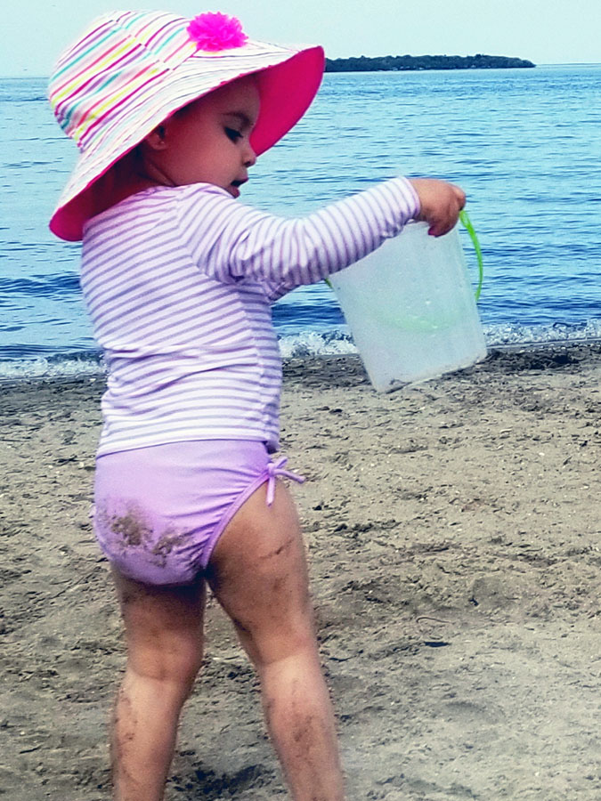 Our little girl, Tessa, enjoying her first trip to the beach. Photo courtesy Michael Fotiou