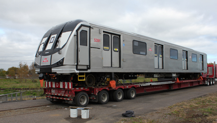 Toronto Rocket cab car arrives by flatbed truck.