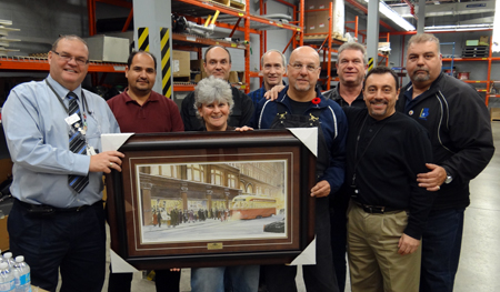 Recipient: Afternoon Storeperson Debbie Content, centre, was congratulated by friends and co-workers on her 25th anniversary with the TTC. Location: Eglinton Garage Stores. Presenter: Materials Management Director Terry Webb, far left.