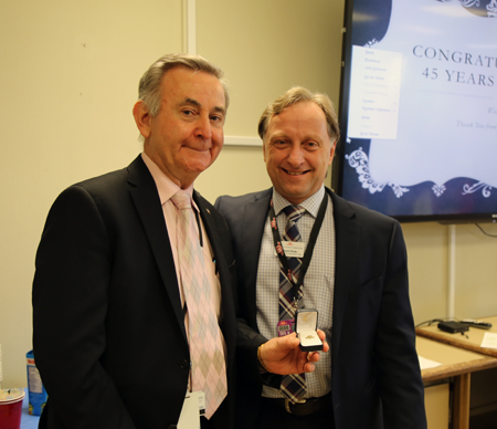 Haluza: 45 years Recipient: Senior System Analyst Walter Haluza, left, celebrated 45 years of service with the TTC. Location: IT Services Department at Head Office. Congratulated by: Chief Financial and Administration Officer Vincent Rodo, right.