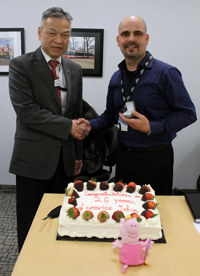 Recipient: Senior Electrical Engineer John Papes, right, receives his 25 year pin. Location: LRV Engineering in Streetcar. Congratulated by: Head Stephen Lam, left.