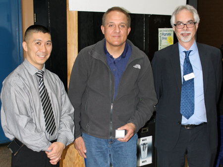 Recipient: General Woodworking Machinist Jimmy Tsorlinas, centre, accepted his 35 year long-service pin. Location: Harvey Shop. Congratulated by: Chief Operating Officer Gary Shortt, right, and Bus Maintenance and Shops Head Rich Wong, left.