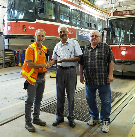 Recipient: Combine Operator Nurallah Jaffer, centre, was congratulated and presented with his 35 year pin recently. Location: Roncesvalles Carhouse. Congratulated by: Foreperson Kevin Reid, left, and pensioner David Somerville, right.
