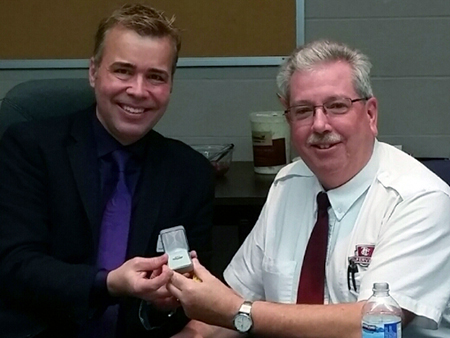 Recipient: Route Supervisor Tim Spears, right, accepts his 35 year long service pin. Location: Eglinton Division. Congratulated by: Division Manager Tim Baubie.