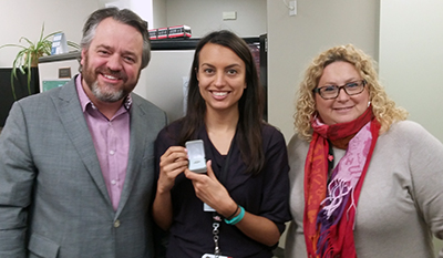 Recipient: Communications Advisor Milly Bernal, centre, received her five year pin. Location: Corporate Communications Department at Head Office. Congratulated by: Executive Director Brad Ross and Manager Susan Sperling.
