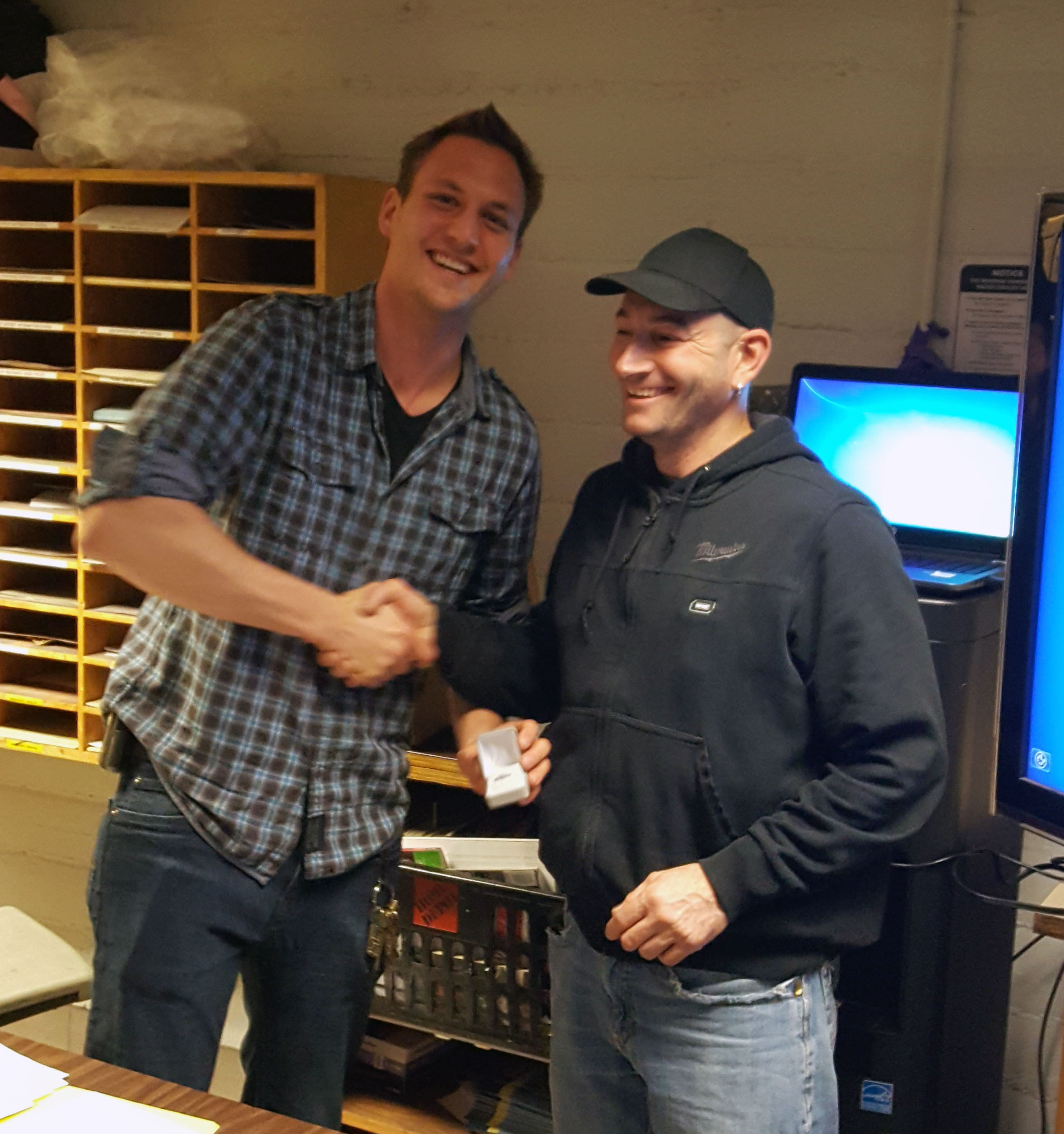 Recipient: Escalator Mechanic Lawrence Micallef, right, picked up his 15 year long-service pin. Location: Elevating Devices in Plant Maintenance. Congratulated by: Foreperson Matthew D’Amore, left.