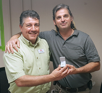 Recipient: Escalator Foreperson Steven Roman, right, received his 20 year long-service pin. Location: Elevating Devices in Plant Maintenance. Congratulated by: Supervisor Frank Cannella, left.