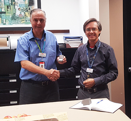 Recipient: OTWO Design Co-ordinator Gary Blanchard, left, received his 20-year long-service pin. Location: Plant Maintenance Department. Congratulated by: Plant Maintenance Engineering Manager Daniel MacKinnon, right, and Head Glen Buchberger (not pictured).