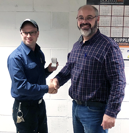 Recipient: Escalator Mechanic Stephen Mapes, left, received his 15-year long-service pin. Location: Elevating Devices Section in Plant Maintenance. Congratulated by: Foreperson Tom Lengyel, right.