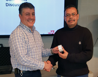 Recipient: Escalator Mechanic Juan Fonseca, right, accepted his 25-year long-service. Location: Plant Maintenance, Elevating Devices. Congratulated by: Supervisor Frank Cannella, left.