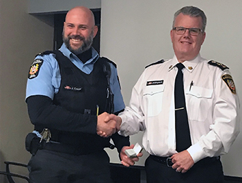 Recipient: Special Constable Joe Costa, left, received his 10-year milestone pin. Location: Transit Enforcement Department. Congratulated by: Head Mike Killingsworth, left.