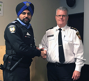 Recipient: Special Constable Kulvinder Dhillon, left, received his five-year pin. Location: Transit Enforcement Department. Congratulated by: Head Mike Killingsworth, left.