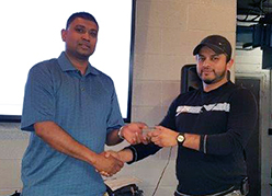 Recipient: Escalator Apprentice Carlton Nunes, right, received his five-year pin. Location: Plant Maintenance Department. Congratulated by: Foreperson Kehr Gomes, left.