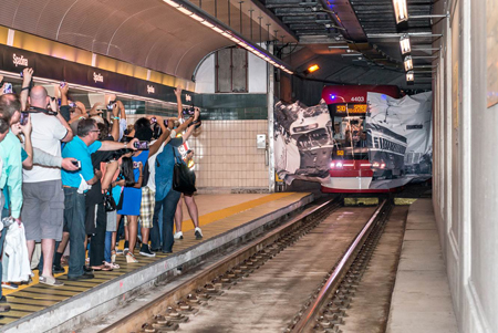 New streetcar breaks through banner at Spadina Station on August  31, 2014