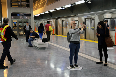 Passenger taking a selfie picture during the opening  of Toronto York Spadina Subway Extension in 2017