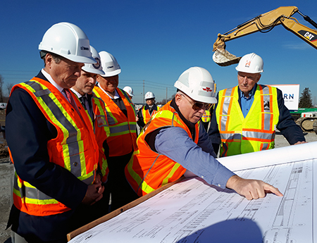 Construction workers looking at plans at McNicoll Division or Garage